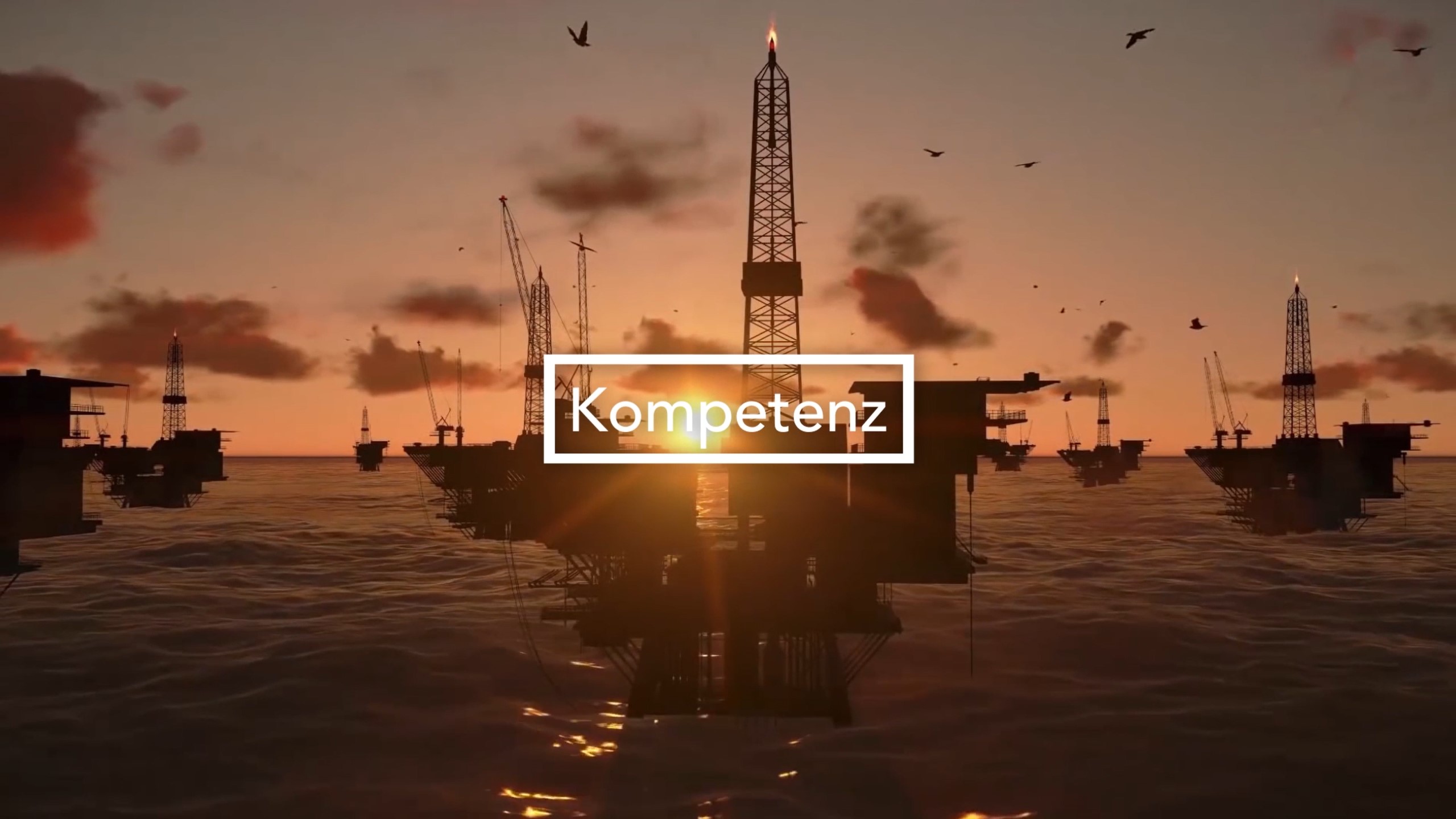 Screenshot aus dem Corporate Video von Liebherr mit dem Schriftzug Kompetenz vor einem Sonnenuntergang und Maritimen technischen Anlagen